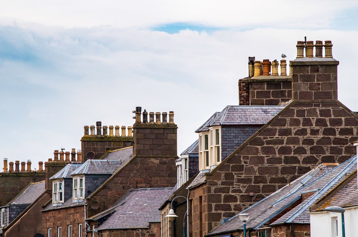 Rooftops of houses with chimney pots and gabled windows